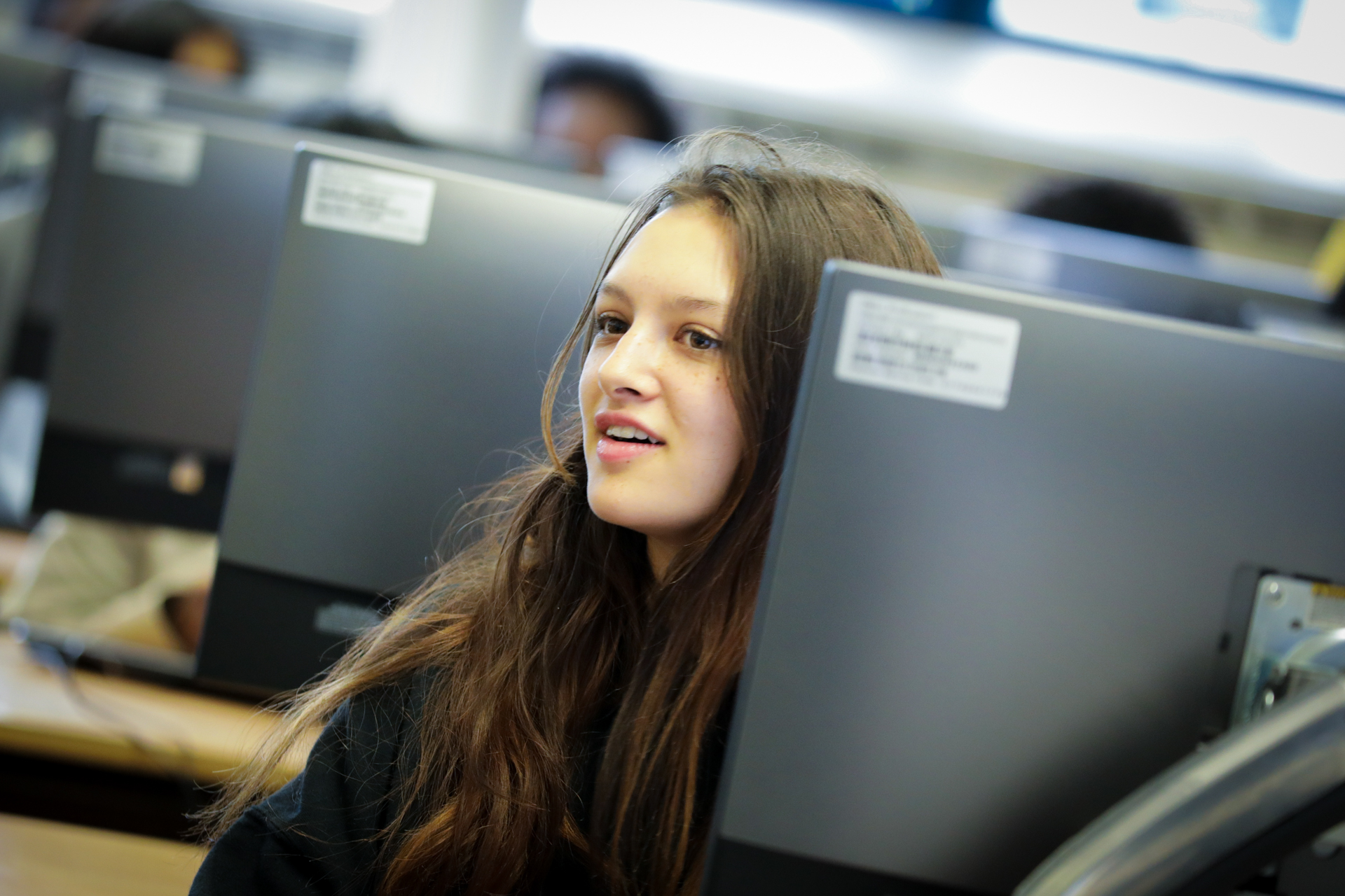 A young person in a university computing classroom.