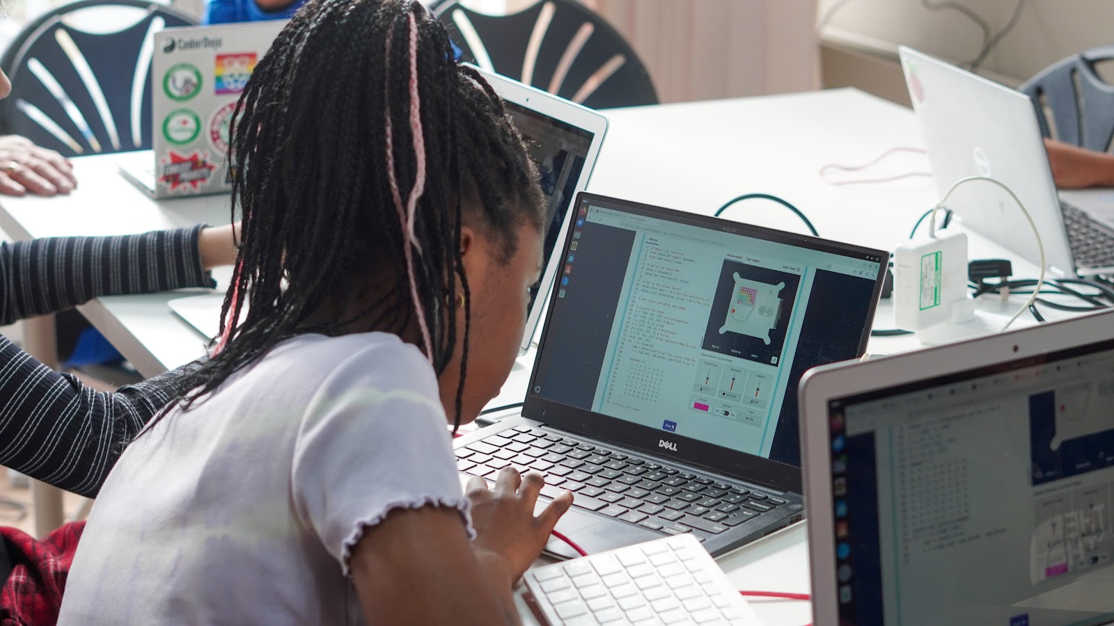 A photograph of a young learner coding on a computer for Mission Zero