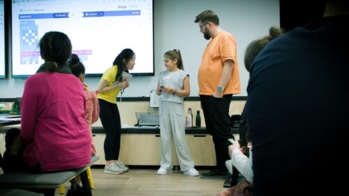 Yang mentors a young person during a CoderDojo session.